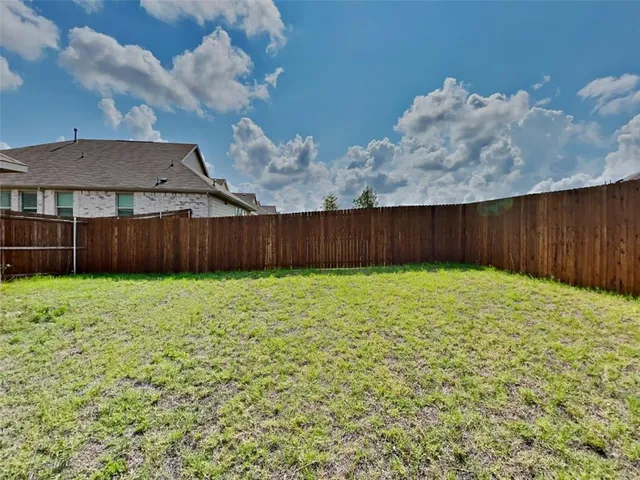 a view of a backyard of the house