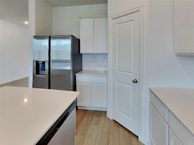 a kitchen with cabinets and stainless steel appliances