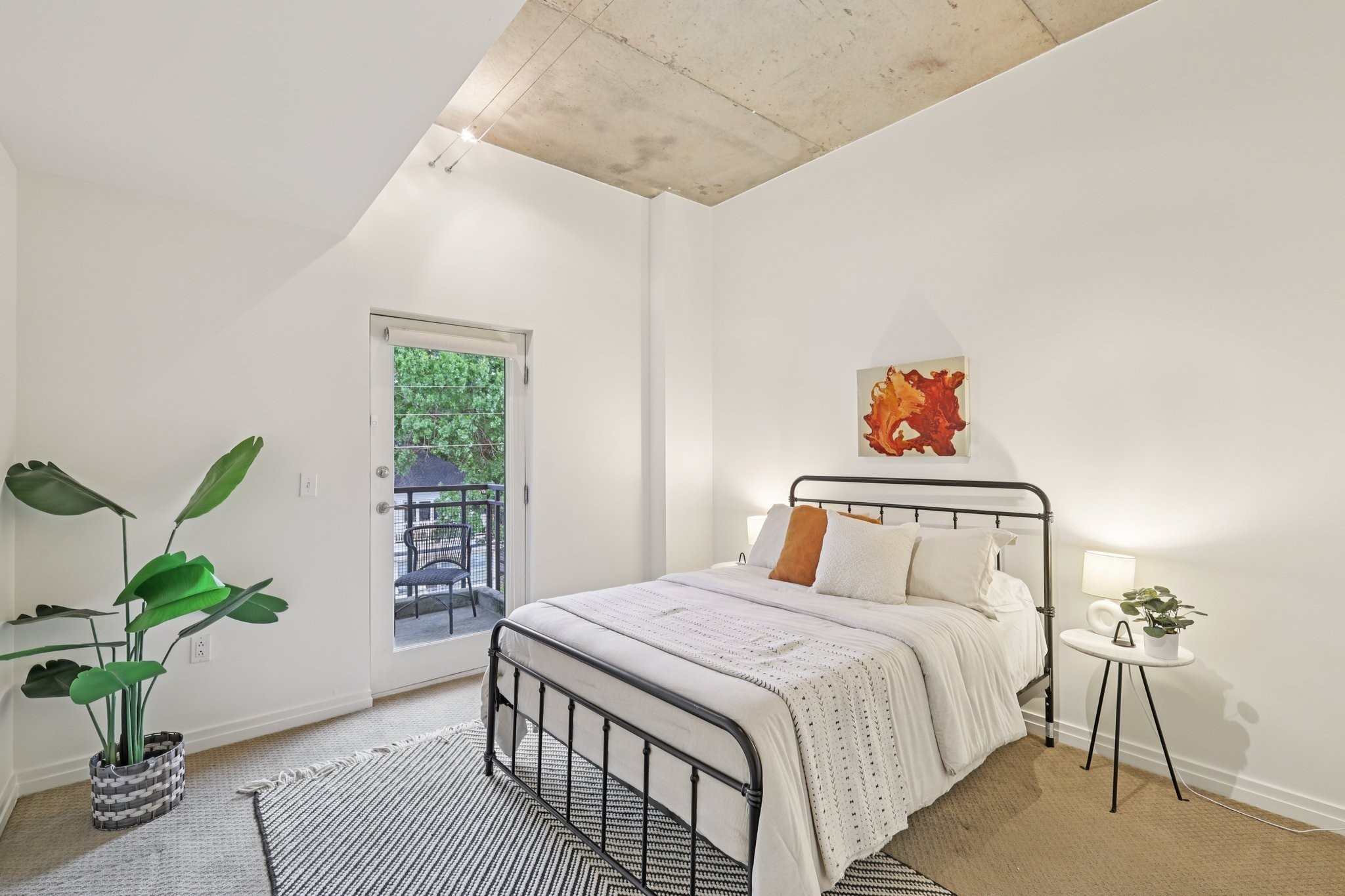 1101 18th Avenue South, Unit 401 Nashville, TN 37212 - Photo 11 of 17 a bedroom with a bed and a potted plant