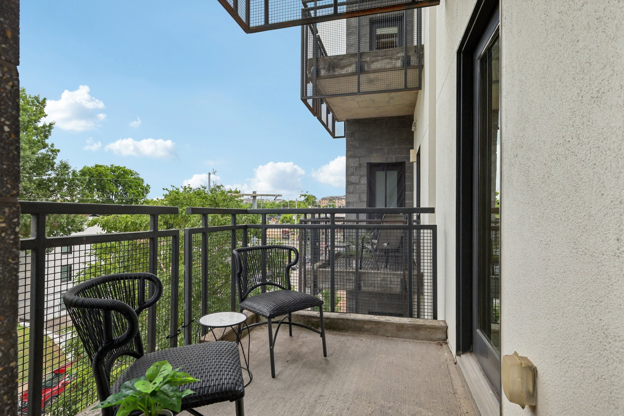 1101 18th Avenue South, Unit 401 Nashville, TN 37212 - Photo 17 of 17 a balcony with table and chairs