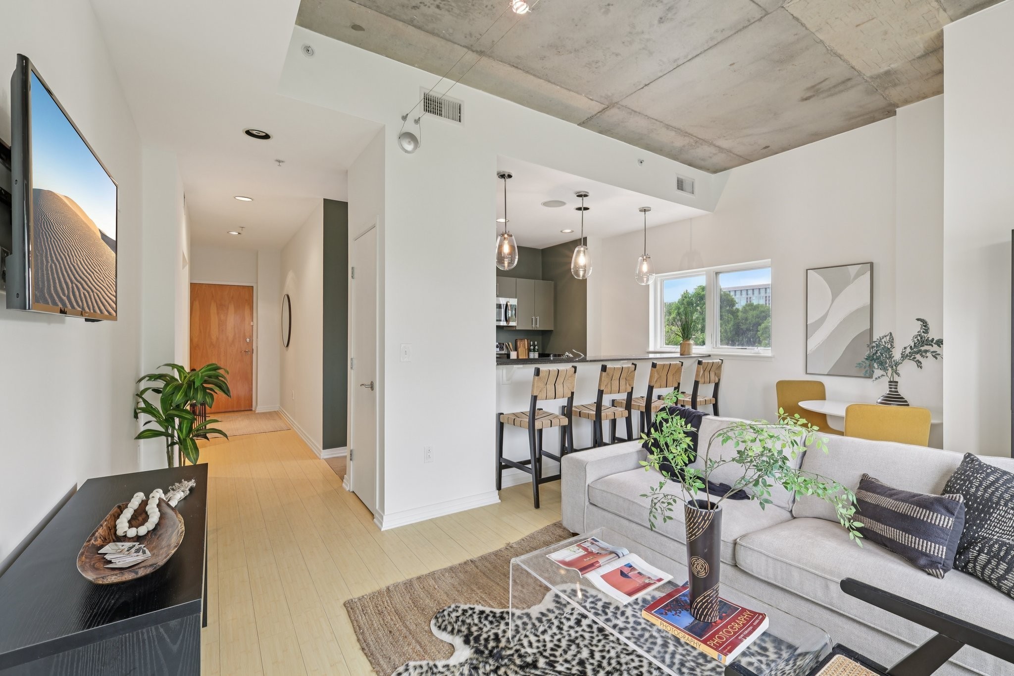 1101 18th Avenue South, Unit 401 Nashville, TN 37212 - Photo 3 of 17 a living room with furniture and a flat screen tv