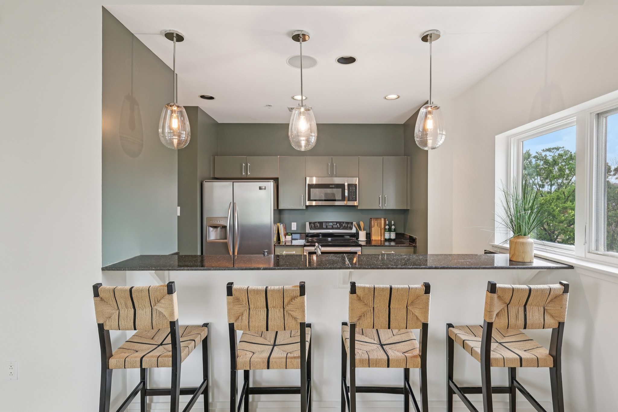 1101 18th Avenue South, Unit 401 Nashville, TN 37212 - Photo 6 of 17 a kitchen with stainless steel appliances granite countertop a kitchen island a stove and a cabinets
