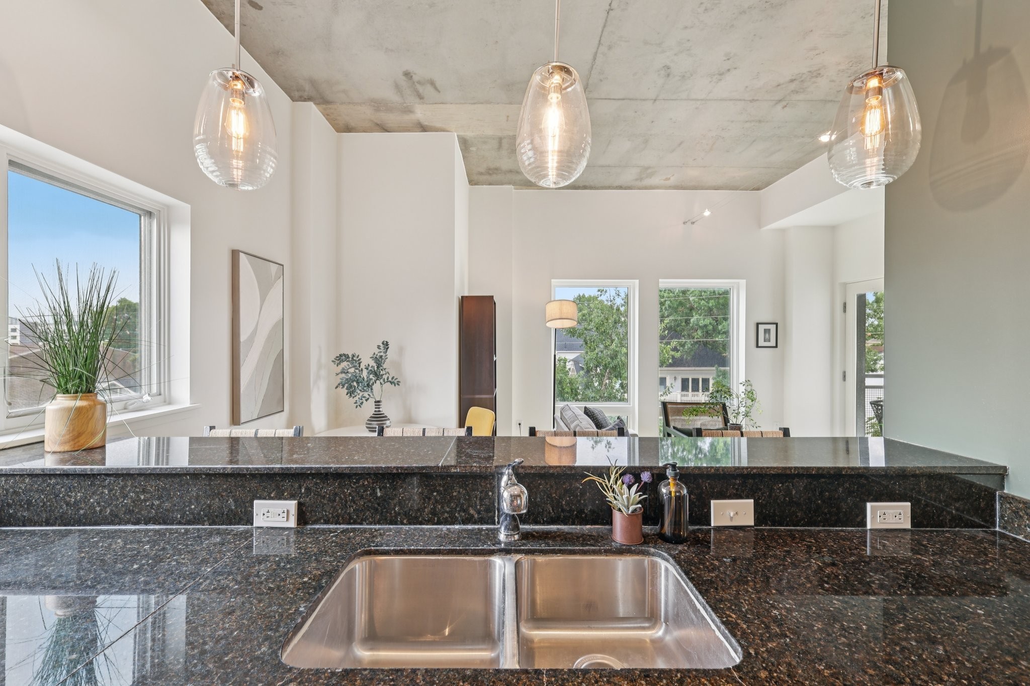 1101 18th Avenue South, Unit 401 Nashville, TN 37212 - Photo 7 of 17 a kitchen with granite countertop a sink and a counter top space