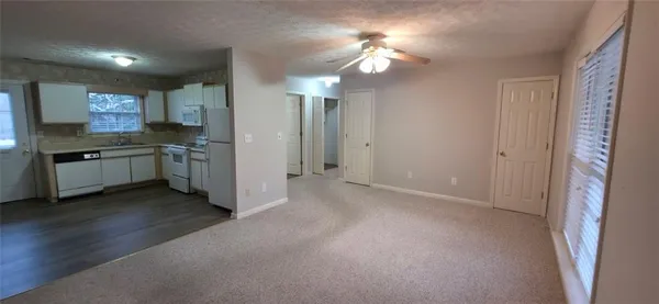 a view of a kitchen with a sink cabinets and wooden floor