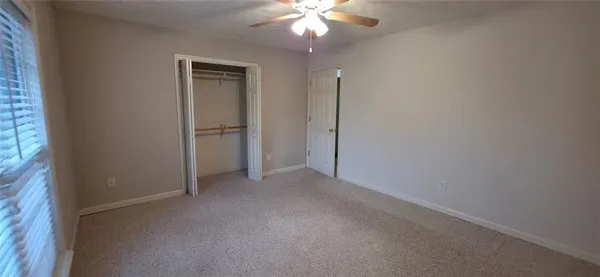 a view of an empty room with a fan