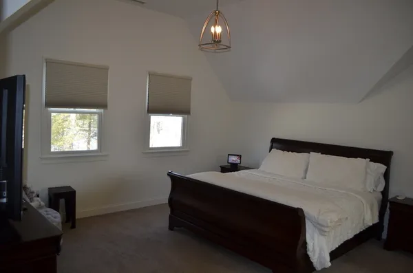 a bedroom with a bed and a night stand