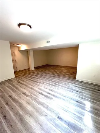 a view of a room with wooden floor