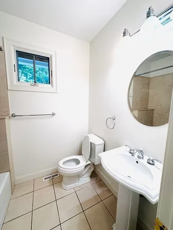 a bathroom with a sink toilet and a mirror
