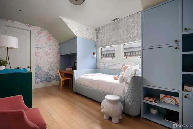 a bed room with furniture and a chair