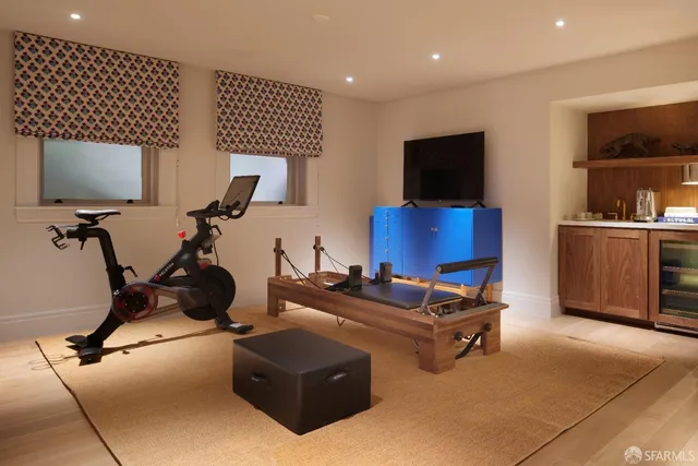 a living room with furniture a flat screen tv and a lamp