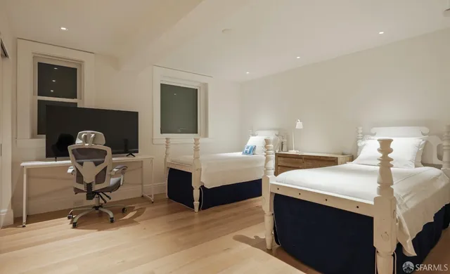 a bedroom with a bed and a desk