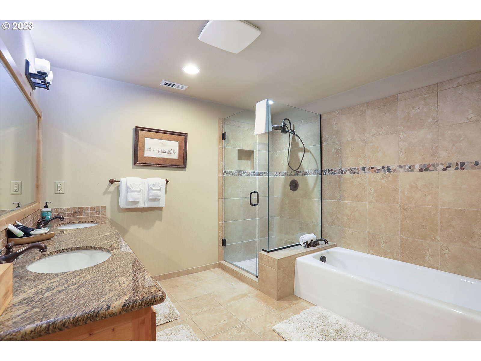 31226 East Collins Lake Road, Unit 27 Government Camp, OR 97028 - Photo 20 of 48 a bathroom with a granite countertop sink a mirror a bathtub and shower