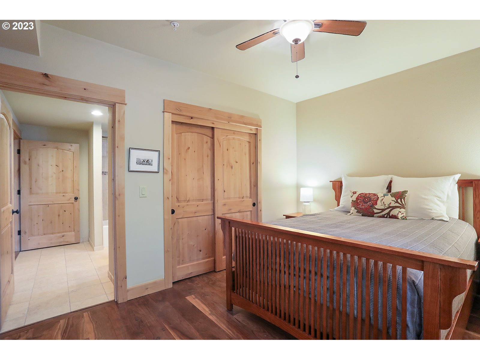 31226 East Collins Lake Road, Unit 27 Government Camp, OR 97028 - Photo 25 of 48 a bedroom with a bed and a chandelier