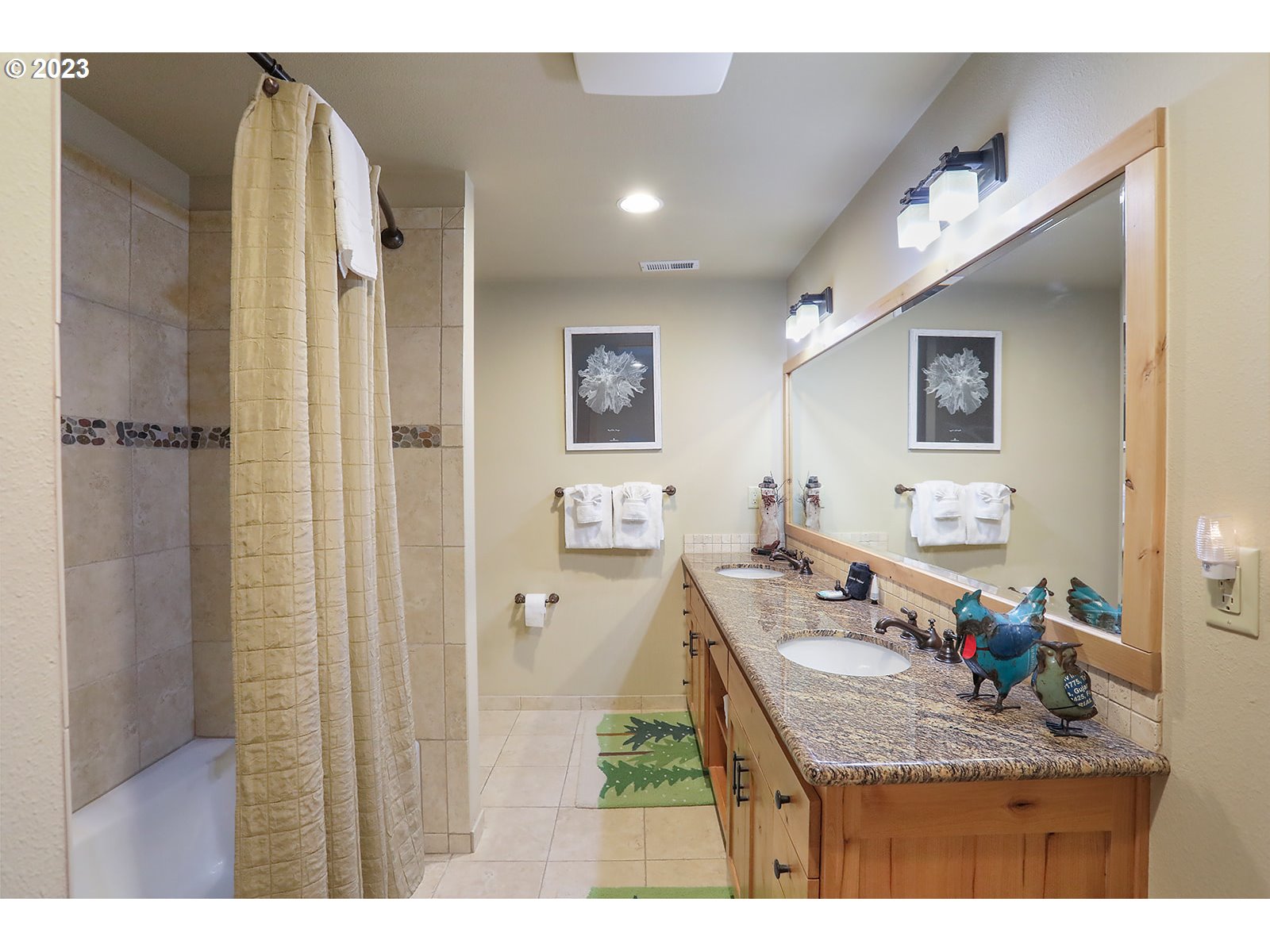 31226 East Collins Lake Road, Unit 27 Government Camp, OR 97028 - Photo 27 of 48 a bathroom with a granite countertop sink a mirror and a shower