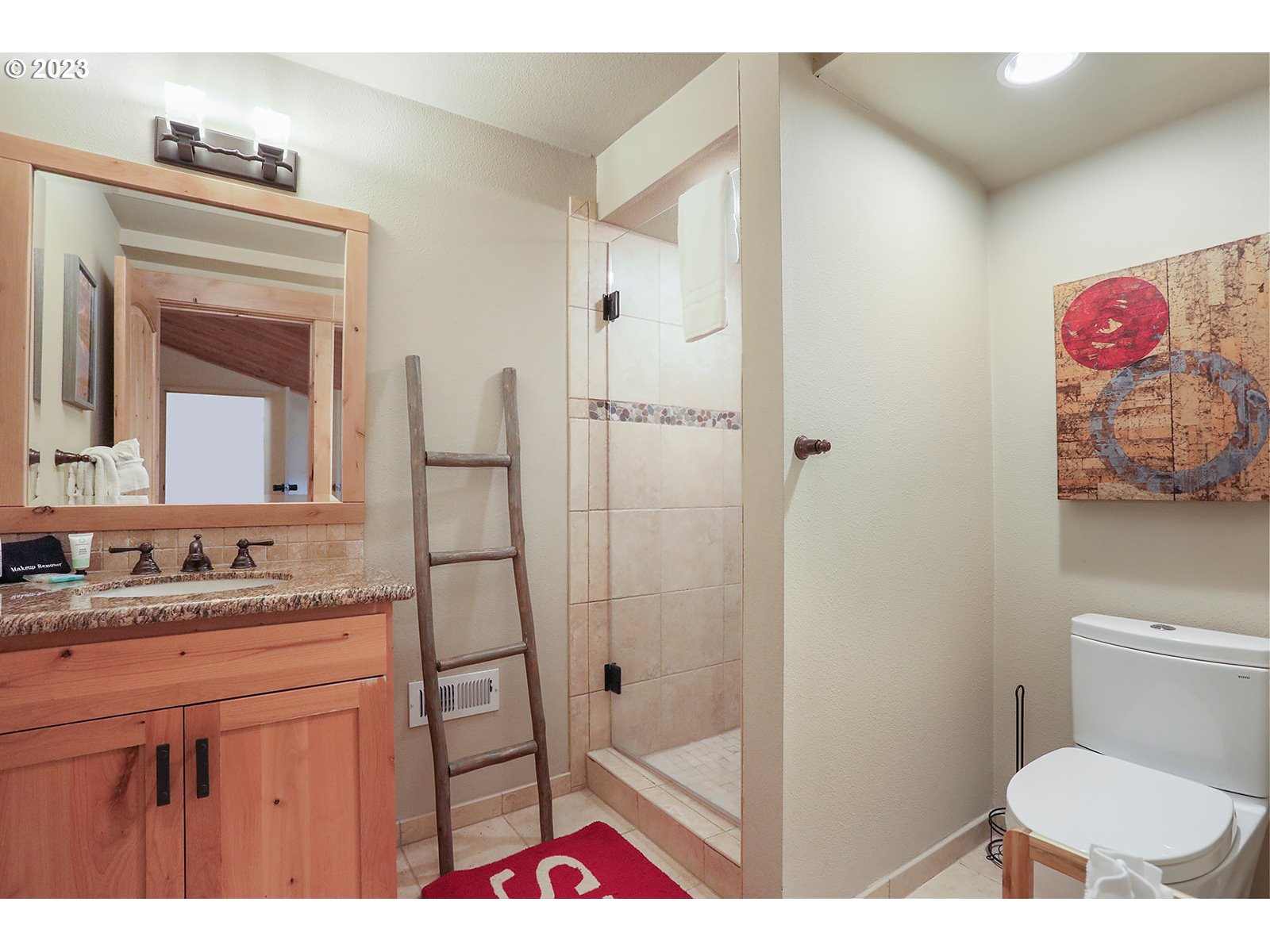 31226 East Collins Lake Road, Unit 27 Government Camp, OR 97028 - Photo 34 of 48 a bathroom with a sink a vanity and a toilet