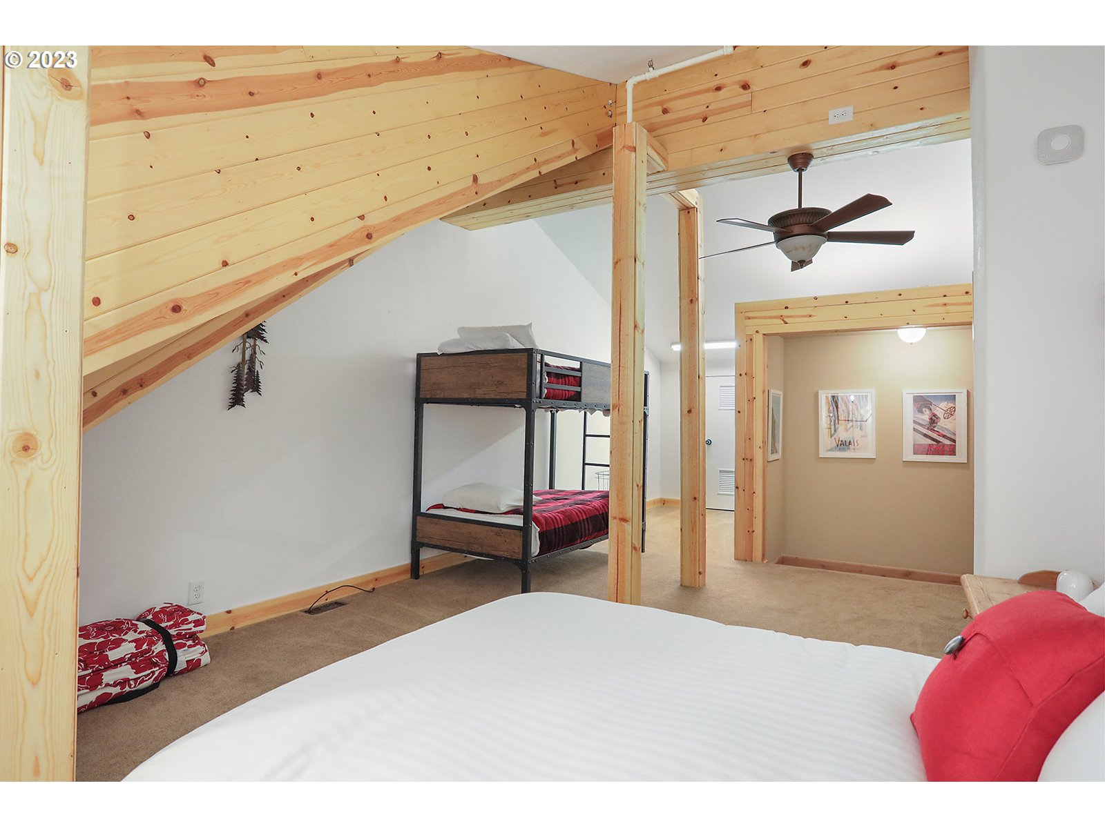 31226 East Collins Lake Road, Unit 27 Government Camp, OR 97028 - Photo 37 of 48 a bedroom with a bed and a chandelier