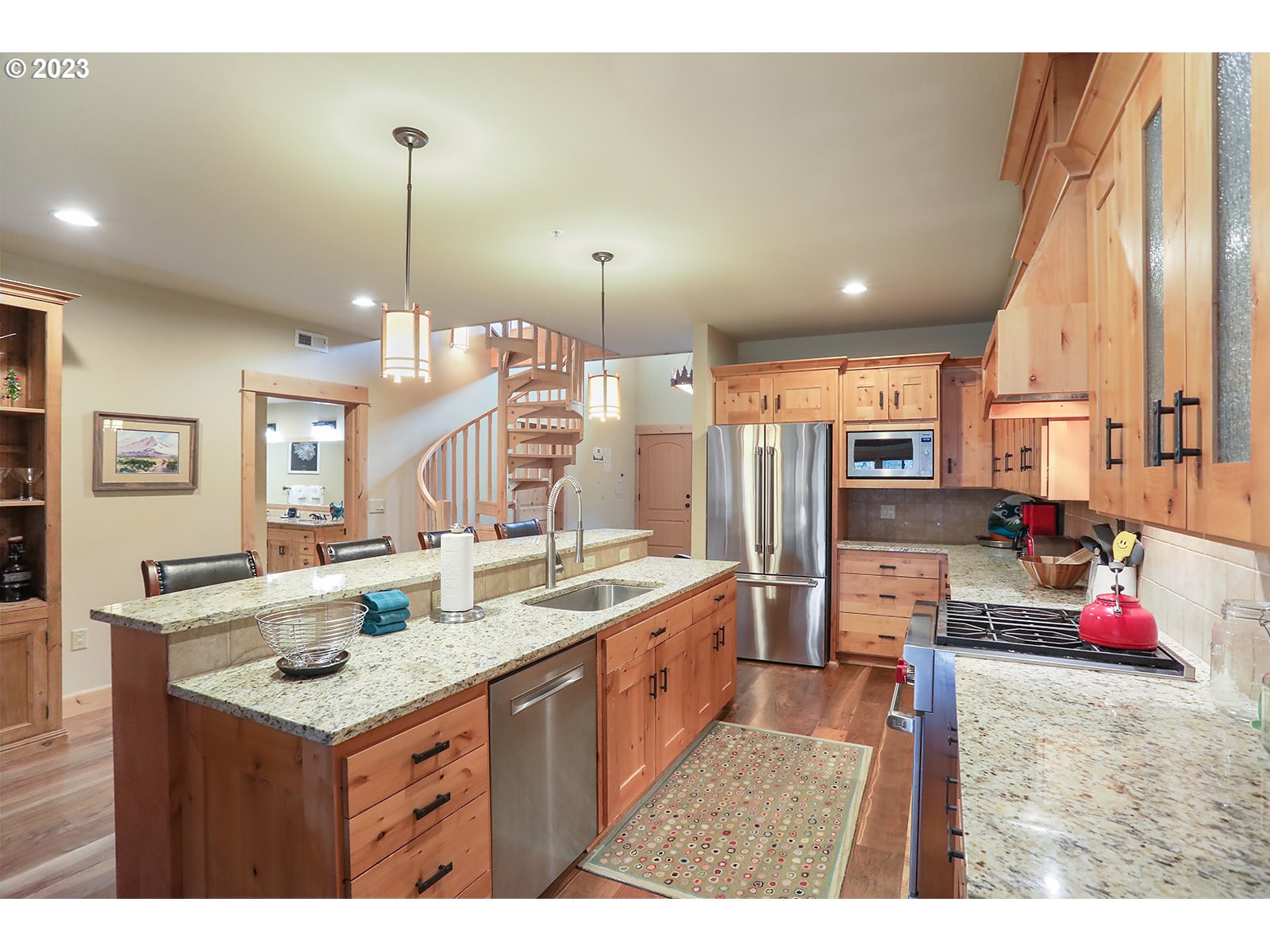 31226 East Collins Lake Road, Unit 27 Government Camp, OR 97028 - Photo 5 of 48 a kitchen with kitchen island granite countertop a sink counter top space and living room view