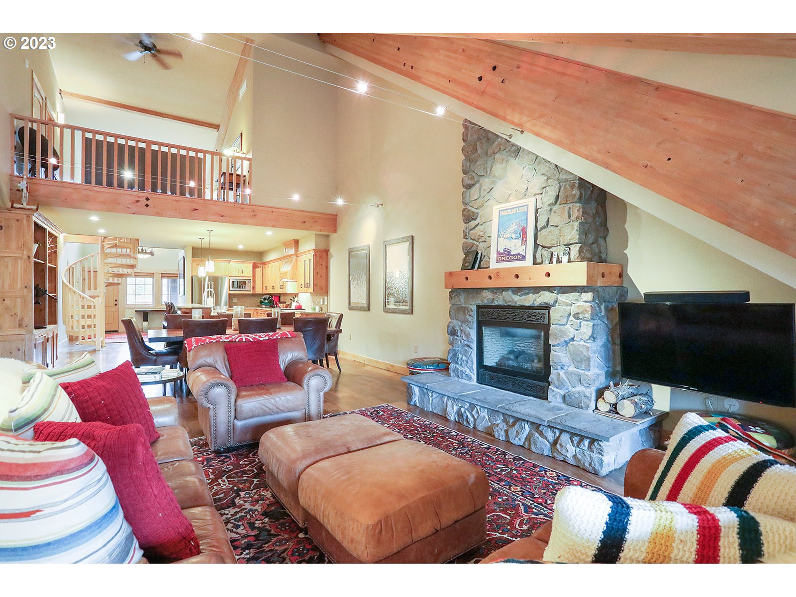 31226 East Collins Lake Road, Unit 27 Government Camp, OR 97028 - Photo 9 of 48 a living room with furniture fireplace and flat screen tv