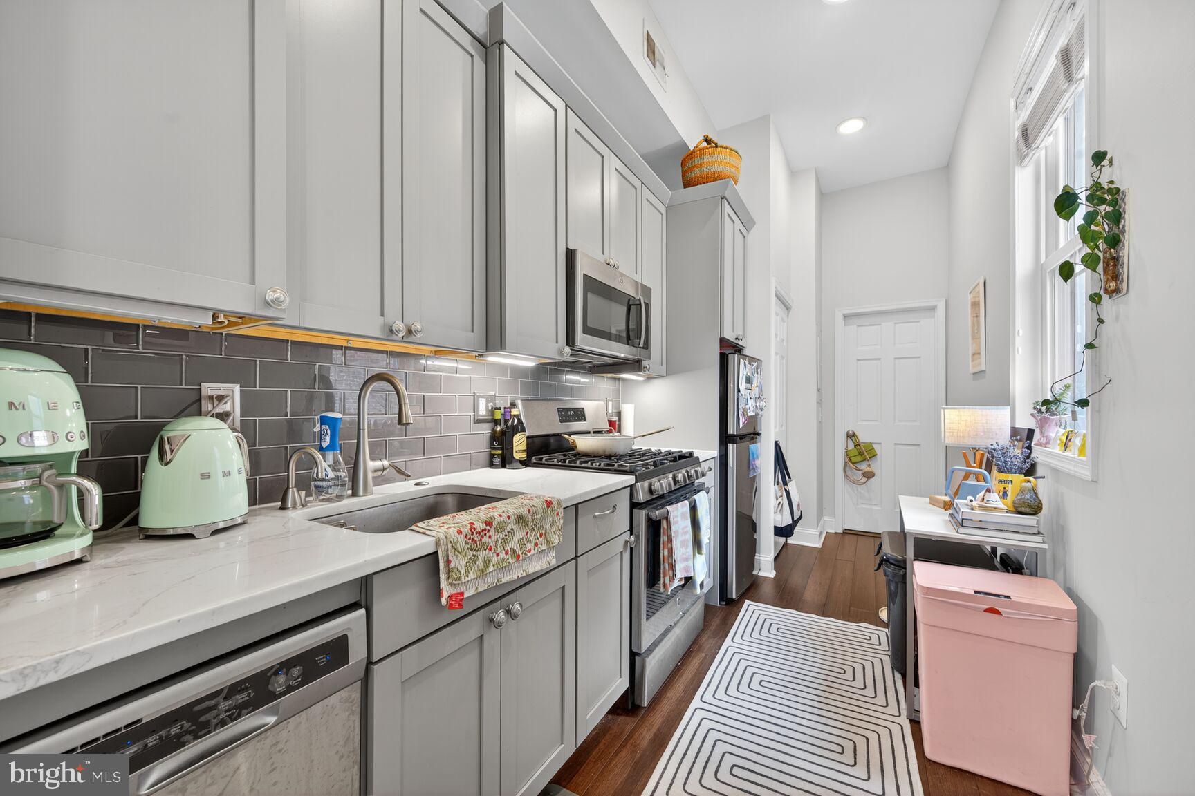 1409 Hopkins Street Northwest Washington, DC 20036 - Photo 14 of 44 a kitchen that has a lot of cabinets in it and appliances
