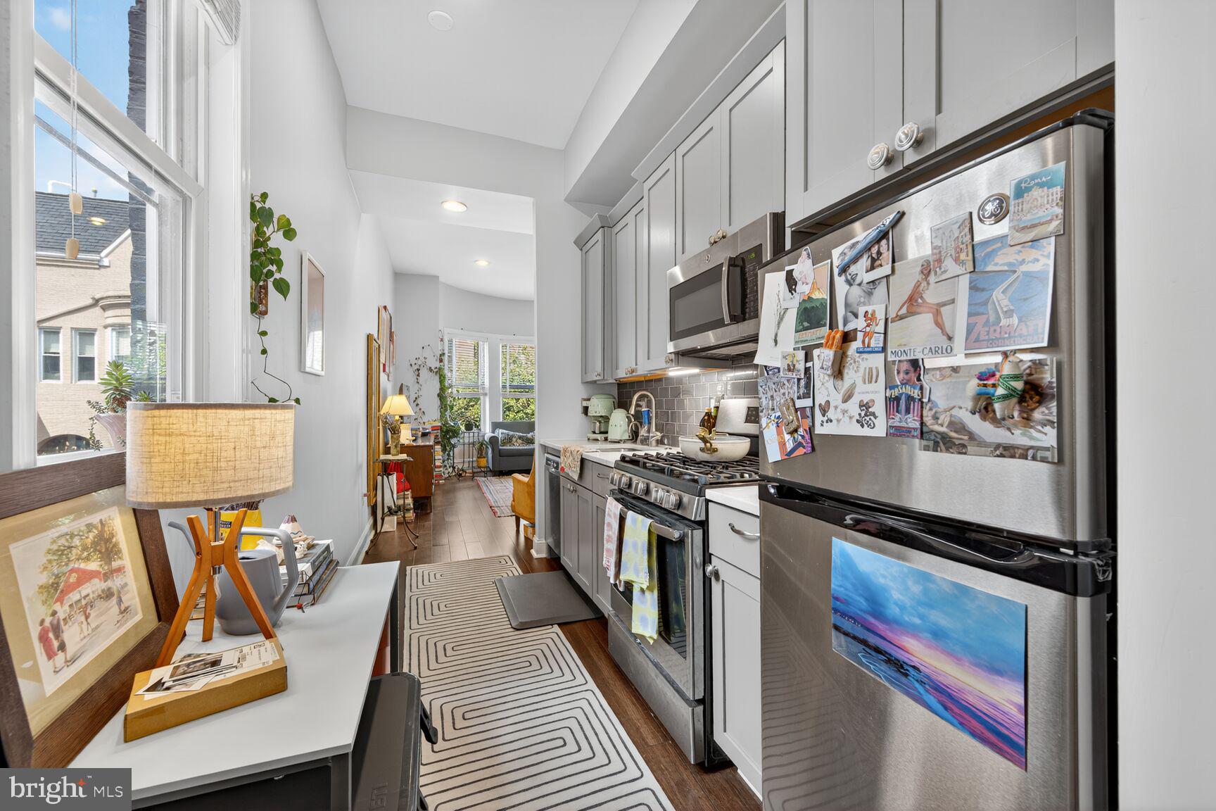 1409 Hopkins Street Northwest Washington, DC 20036 - Photo 15 of 44 a kitchen with stainless steel appliances granite countertop a stove a sink dishwasher and cabinets with wooden floor
