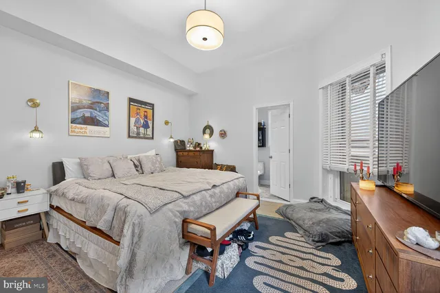 a bedroom with a bed and a couch