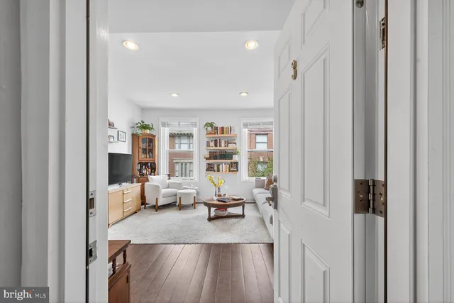a living room with furniture a couch and a flat screen tv