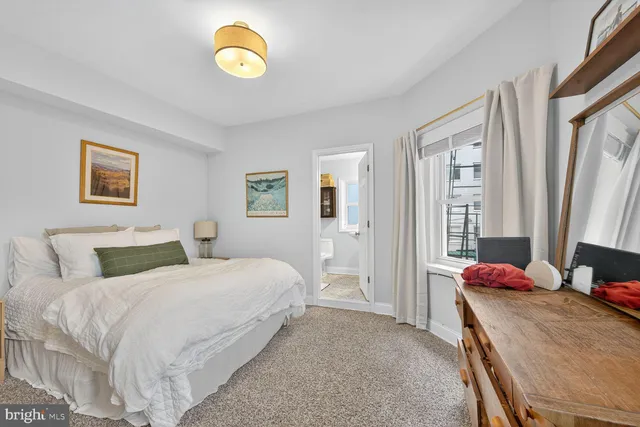 a bedroom with a bed and a lamp