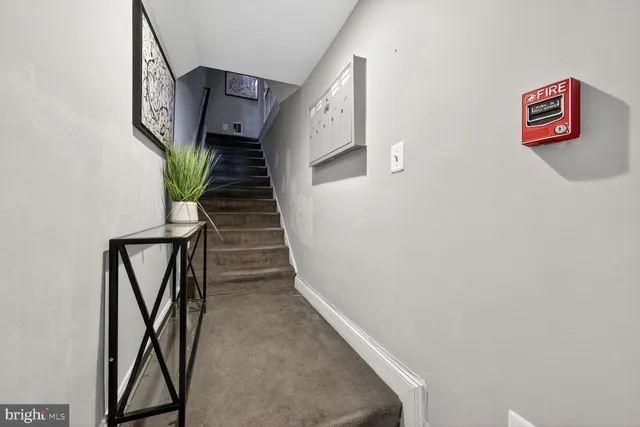 an empty room with wooden floor and window