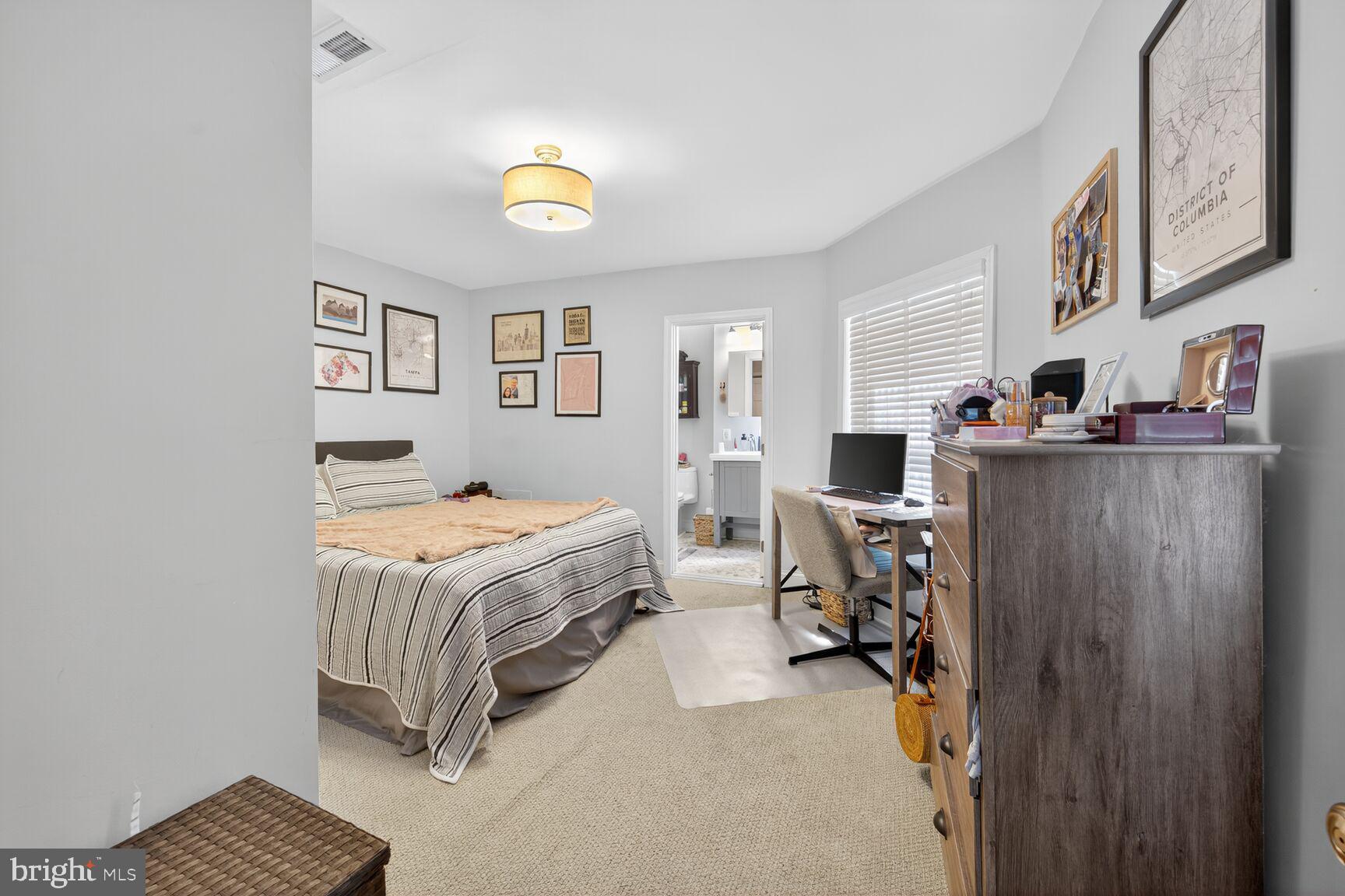 1409 Hopkins Street Northwest Washington, DC 20036 - Photo 34 of 44 a bedroom with a bed and a chandelier