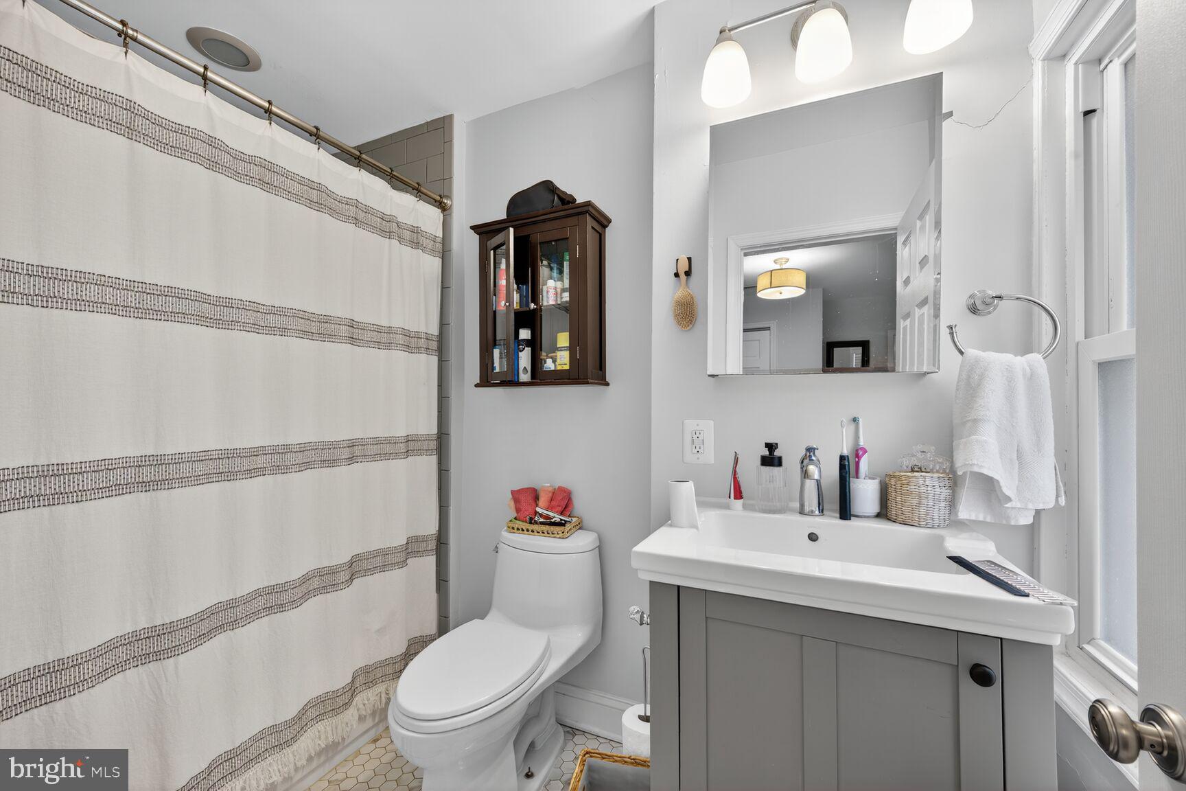 1409 Hopkins Street Northwest Washington, DC 20036 - Photo 37 of 44 a bathroom with a toilet sink and mirror