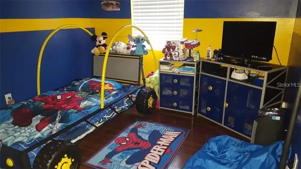 a bedroom with furniture and a flat screen tv