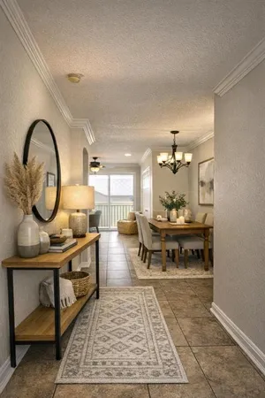 a living room with furniture a mirror and a table