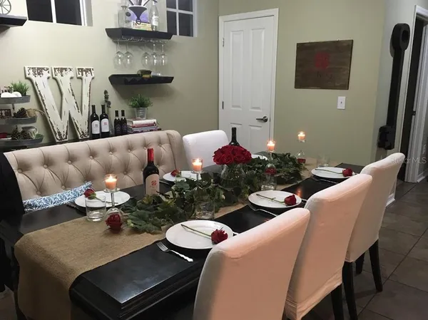 a dining room with furniture and wooden floor