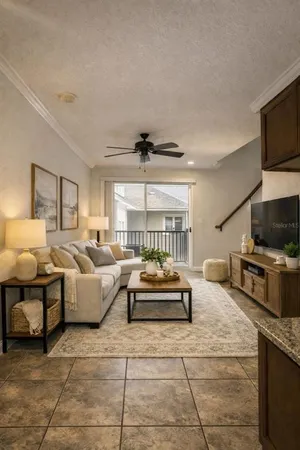 a living room with furniture a flat screen tv and a fireplace