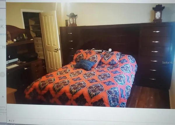 a bedroom with a bed and dresser