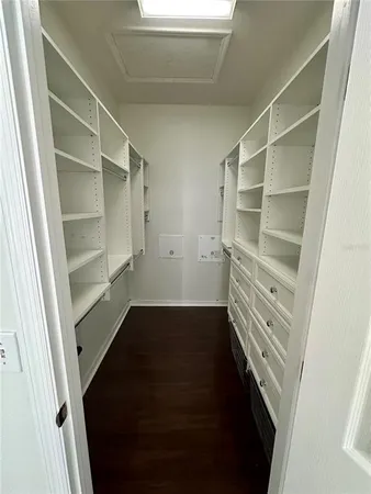 a view of walk in closet with empty racks