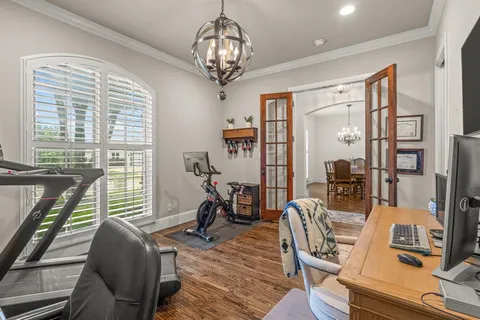 a view of a dining room with furniture wooden floor and chandelier