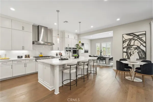 a open kitchen with stainless steel appliances granite countertop a stove and chairs