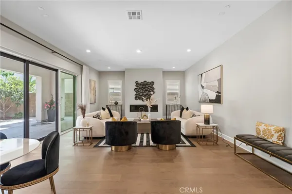 a living room with furniture large window and a table