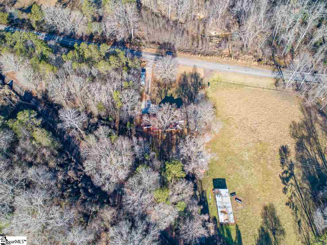 1026 Belle Shoals Road Pickens, SC 29671 - Photo 7 of 33 Home is hidden by trees in this photo. the building you see in the field is a barn next door.