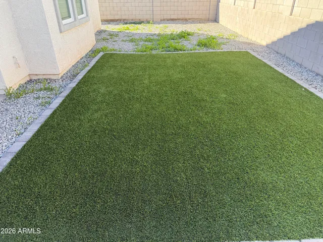 a view of yard with swimming pool and green space