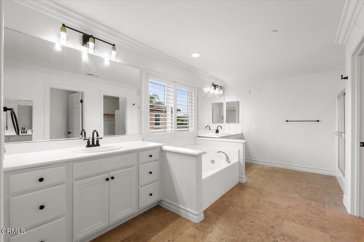 727 Entrada Drive Oxnard, CA 93030 - Photo 8 of 12 a spacious bathroom with a double vanity sink a mirror a bathtub and window