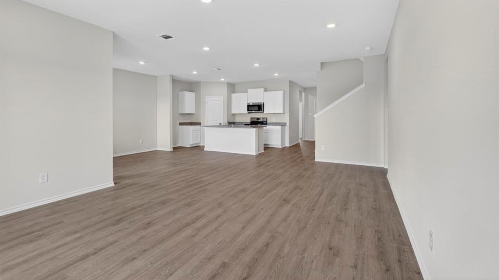1683 Mantle Road Crandall, TX 75114 - Photo 10 of 31 Open-concept living area featuring wood-finish flooring, recessed lighting, and light gray wall tones
