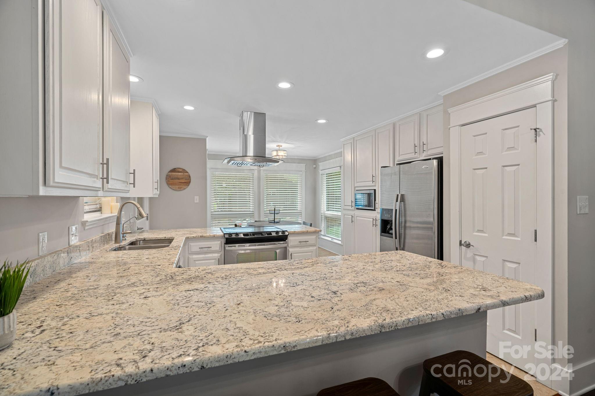 345 Jib Court Davidson, NC 28036 - Photo 11 of 40 a kitchen with stainless steel appliances granite countertop a sink refrigerator and cabinets