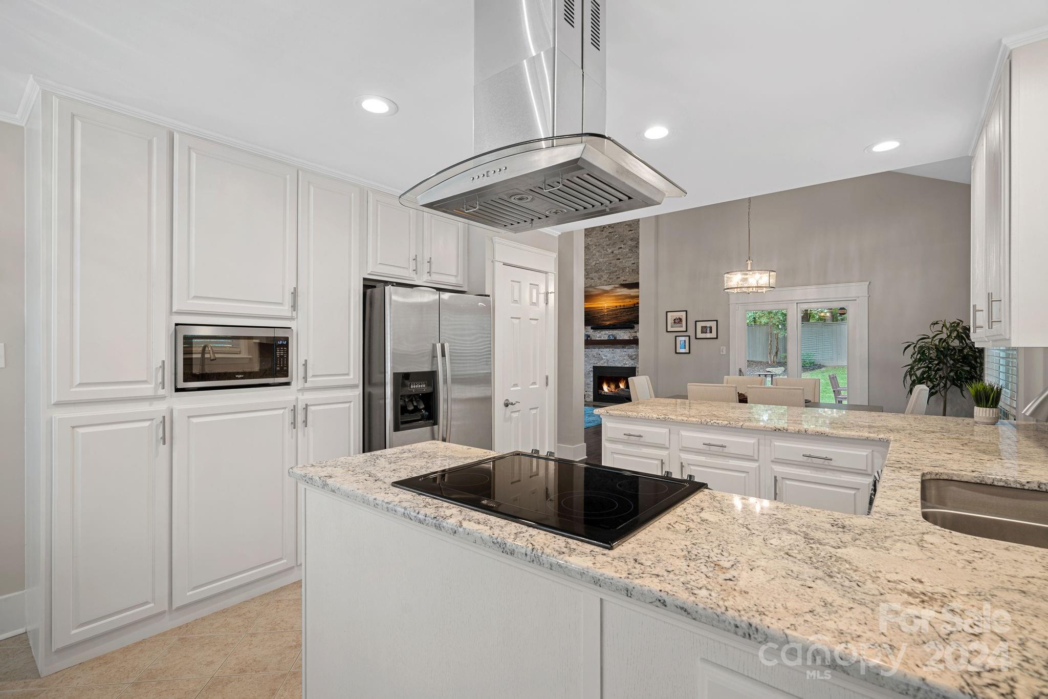 345 Jib Court Davidson, NC 28036 - Photo 14 of 40 a kitchen with a sink a counter top space cabinets and stainless steel appliances