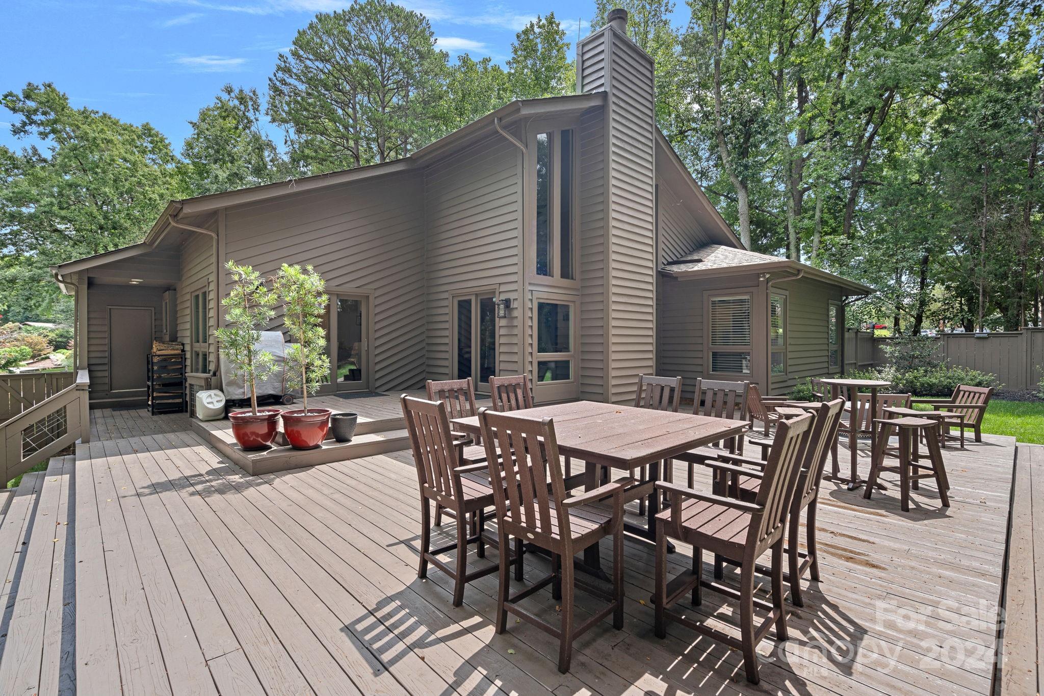 345 Jib Court Davidson, NC 28036 - Photo 29 of 40 a view of a patio with table and chairs with wooden floor and fence
