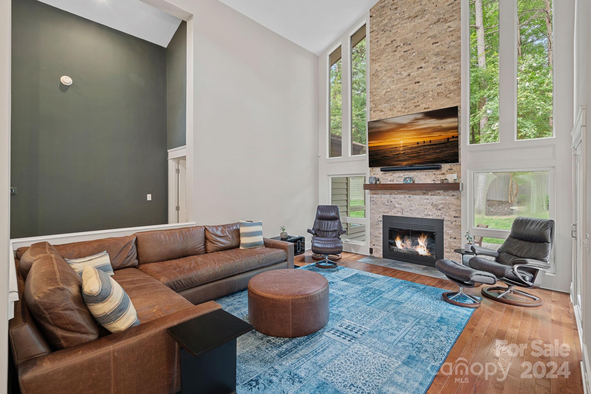 345 Jib Court Davidson, NC 28036 - Photo 5 of 40 a living room with furniture a flat screen tv and a fireplace