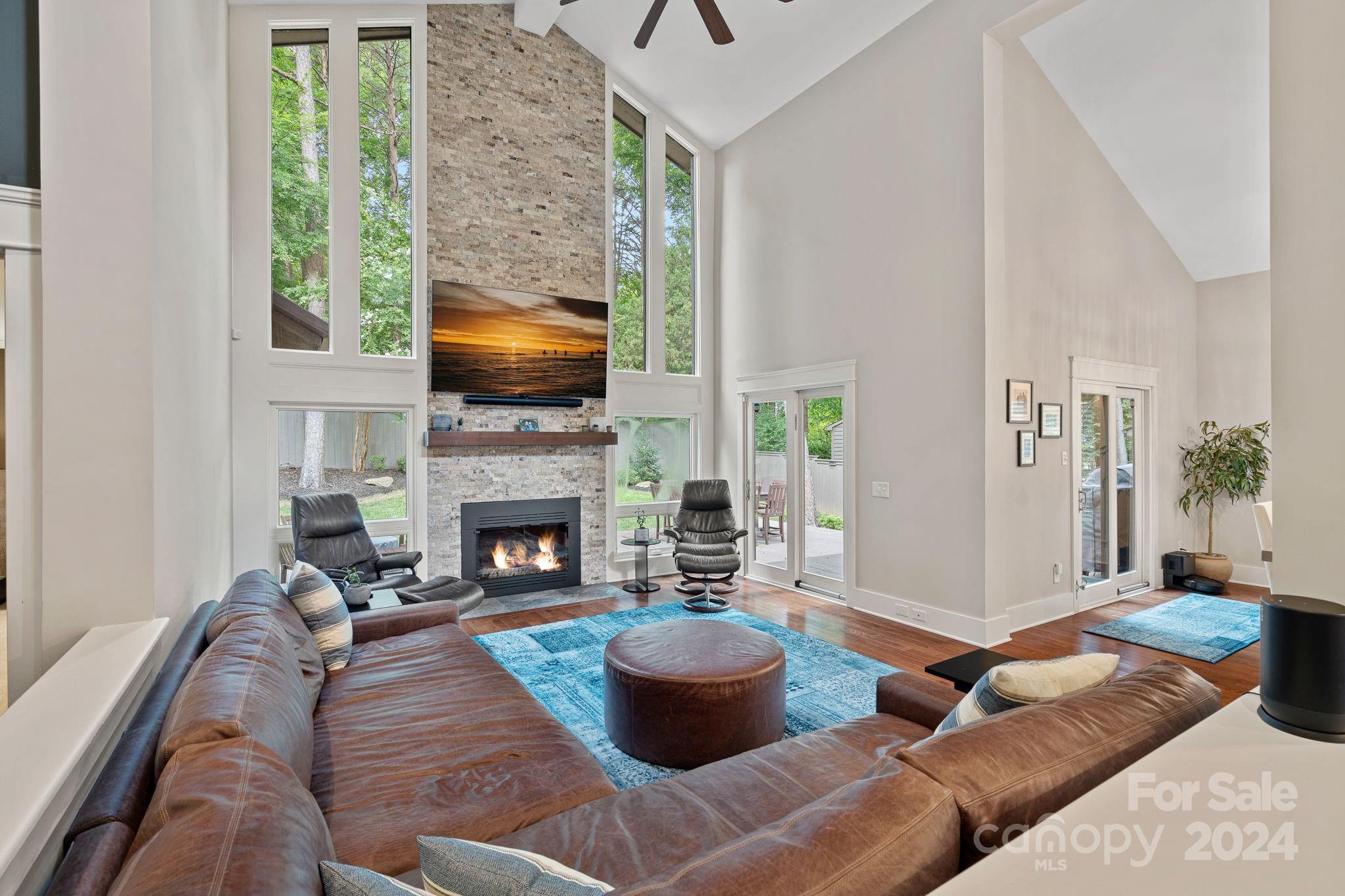 345 Jib Court Davidson, NC 28036 - Photo 6 of 40 a living room with furniture a fireplace and a floor to ceiling window