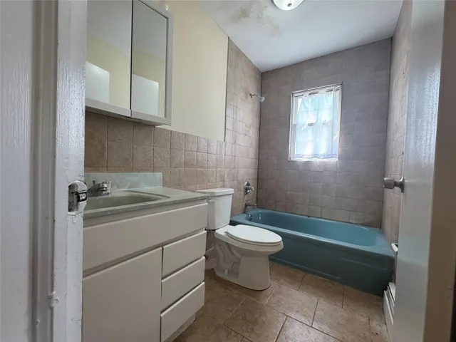 a bathroom with a sink a toilet and bathtub