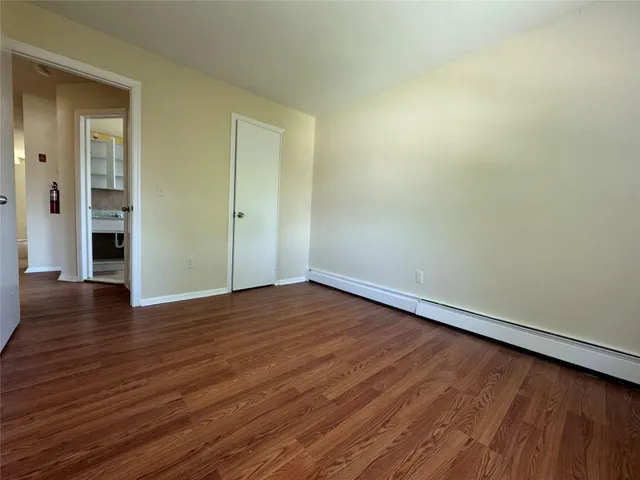 a view of an empty room and wooden floor